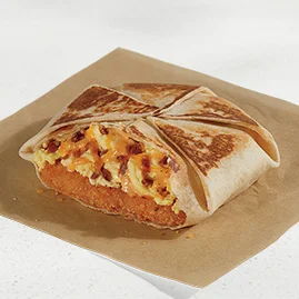 Menu 60 A Breakfast Crunchwrap Bacon, filled with a hash brown, fluffy cage-free eggs, bacon, Jalapeño sauce, and shredded cheddar cheese, all folded into a Crunchwrap form.