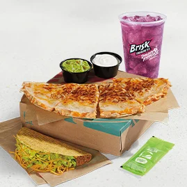 Menu 73 Cantina Chicken Quesadilla Meal featuring a Cantina Chicken Quesadilla, an Avocado Verde Salsa packet, guacamole and reduced-fat sour cream, a Crunchy Taco, and a Medium fountain drink.