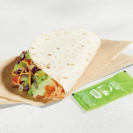 Menu 104 A Cantina Chicken Soft Taco, served with an Avocado Verde Salsa packet.