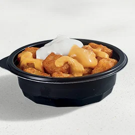 Menu 99 A Cheesy Fiesta Potatoes dish, featuring seasoned potato bites topped with Nacho Cheese Sauce and reduced-fat sour cream.