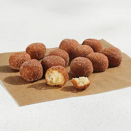 Menu 65 Cinnabon Delights® 12 Pack, dusted in cinnamon sugar and filled with Cinnabon® cream-cheese frosting.