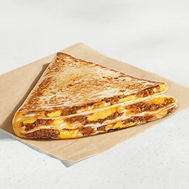 Menu 97 A Classic Stacker, filled with seasoned beef, a blend of cheeses, and warm Nacho Cheese sauce.