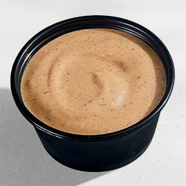 Menu 217 Creamy Jalapeño Sauce, served in a Taco Bell-branded container.