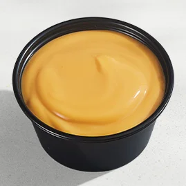 Menu 215 Nacho Cheese Sauce, served in a Taco Bell-branded container.