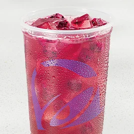 Dragonfruit Berry Agua Fresca with freeze‑dried dragonfruit pieces, mixed berry flavor and green tea base in clear iced cup