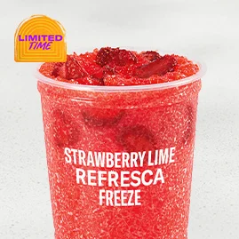 Strawberry Lime Refresca Freeze with real freeze‑dried strawberry pieces, tart lime flavor and ice in clear cup