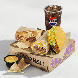 Menu 56 Build Your Own Luxe Cravings Box featuring a crunchy taco, grilled burrito, tortilla chips, nacho cheese dipping sauce, and a Pepsi fountain drink served in a Taco Bell box.